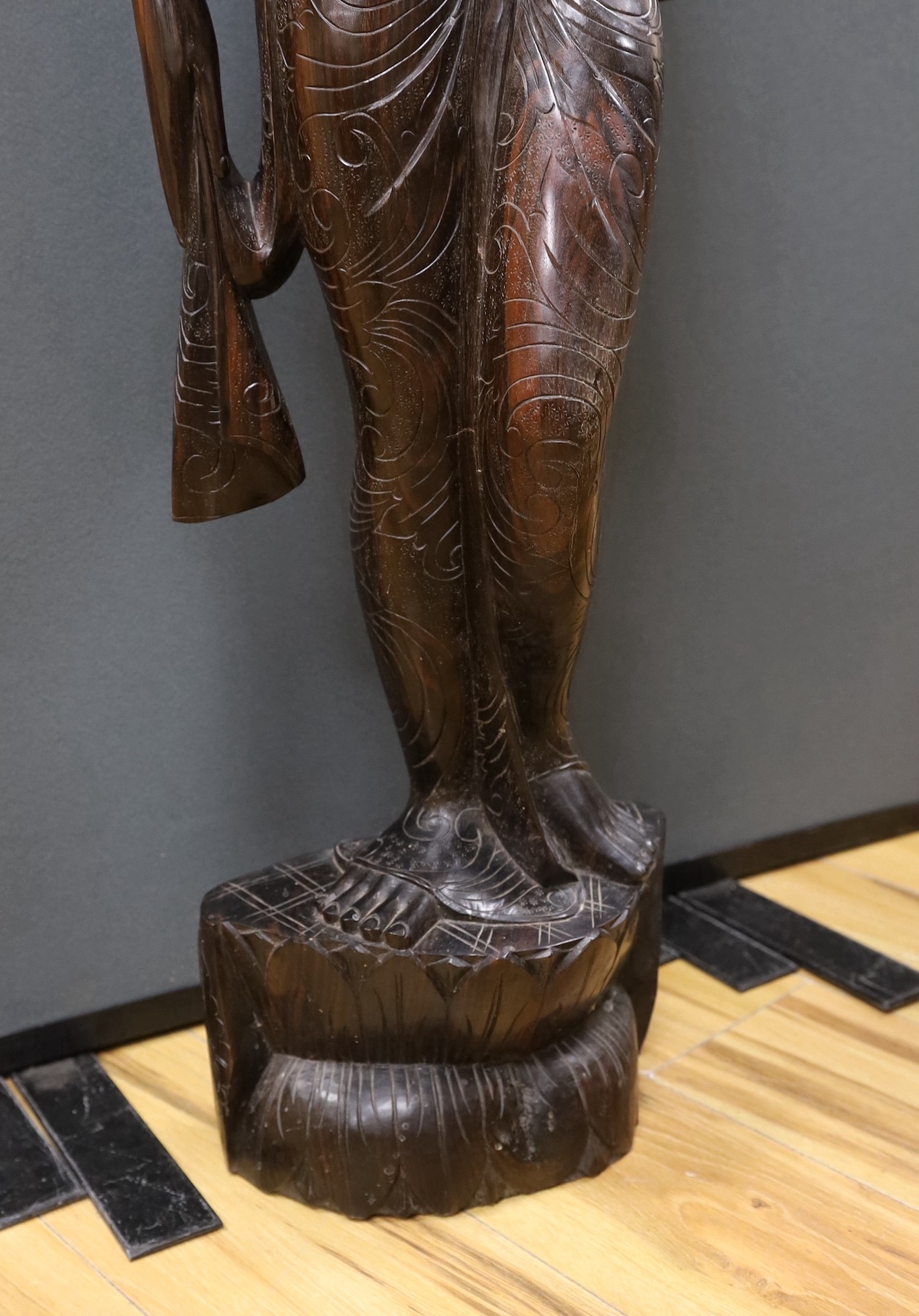 An unusually large and well-carved Balinese ebony figure of a standing young girl, early/mid 20th century. From a Bournemouth estate, 105cm high